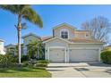 Well-maintained home featuring a spacious two-car garage and neutral exterior, complemented by beautiful landscaping at 1655 Pinyon Pine Dr, Sarasota, FL 34240
