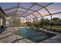 Relaxing screened-in pool with an in-ground pool, waterfall feature and spacious deck for entertaining friends and Gathering at 1655 Pinyon Pine Dr, Sarasota, FL 34240