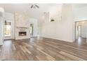 A bright living room features hardwood flooring and a stone fireplace at 1730 Hudson St, Englewood, FL 34223