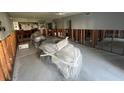 Spacious room with exposed framing and covered furniture, offering a blank canvas at 1801 Gulf N Dr # 184, Bradenton Beach, FL 34217