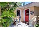 Charming front entrance with a bright red door and decorative accents at 2212 6Th W St, Palmetto, FL 34221