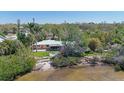 Waterfront property with a lush yard, sandy beach, and serene water views at 2212 6Th W St, Palmetto, FL 34221
