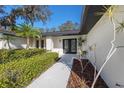 Elegant front entrance with a landscaped walkway and a modern, inviting entryway at 2846 Pheasant Run, Clearwater, FL 33759