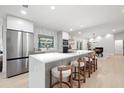 Modern kitchen with a large island, stainless steel appliances, and sleek countertops at 2846 Pheasant Run, Clearwater, FL 33759
