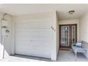 The garage and entryway feature a bright, clean space, and the front door has glass panels for natural light at 285 Madeira Cir, Tierra Verde, FL 33715
