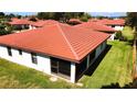 Backyard featuring a well-maintained lawn and a glimpse of the tile roof at 3002 Vivienda Dr # 22, Bradenton, FL 34207