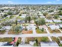 Aerial view of a charming single-story home nestled in a well-maintained neighborhood with tree lined streets at 3016 Taunton W Dr, Bradenton, FL 34205