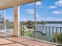 Enjoy the lake view from this screened lanai, with views of the water, boat dock, and lush foliage at 3424 Lake Bayshore Dr # 405, Bradenton, FL 34205