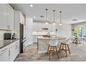 Modern kitchen featuring white cabinets, stainless steel appliances, and a stylish kitchen island at 3442 Chestertown Loop, Bradenton, FL 34211