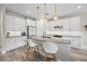 Modern kitchen featuring white cabinets, stainless steel appliances, and a stylish kitchen island at 3442 Chestertown Loop, Bradenton, FL 34211