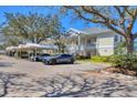 Exterior angle of condo building with covered parking; multiple cars and landscaping featured at 3701 54Th W Dr # 103, Bradenton, FL 34210