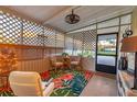 Cozy screened porch featuring outdoor seating, lighting, and floral rug at 3912 14Th E St, Ellenton, FL 34222