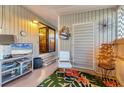 Comfortable screened porch with a TV, bright rug, and inviting decor at 3912 14Th E St, Ellenton, FL 34222