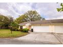 Charming single-story villa with a two-car garage and a well-maintained front yard with mature landscaping at 4018 Oakhurst Dr # 3181, Sarasota, FL 34233
