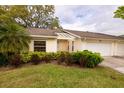 Villa showcasing verdant lawn and shrubbery, an attached two-car garage, and covered entry, exuding curb appeal at 4018 Oakhurst Dr # 3181, Sarasota, FL 34233