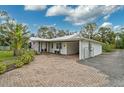 A charming single-story home with a long driveway and an attached carport and garage at 4116 34Th E Ave, Bradenton, FL 34208