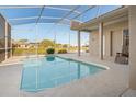 Screened in pool with lake view and outdoor seating area at 4173 Hearthstone Dr, Sarasota, FL 34238