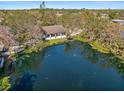 An aerial view showcases this beautiful home nestled alongside a tranquil pond and lush greenery at 4540 Murdock Ave, Sarasota, FL 34231
