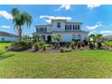 Charming two-story home boasting an appealing facade, meticulously manicured landscaping, and mature palms at 4789 Vasca Dr, Sarasota, FL 34240