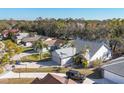 Wide aerial view of a cozy home with a two-car garage and a beautiful community lake at 5047 82Nd E Way, Sarasota, FL 34243