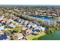 Aerial view of a home near a lake surrounded by lush trees and neighborhood homes at 5047 82Nd E Way, Sarasota, FL 34243