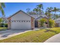Inviting single-story home featuring a two-car garage, mature landscaping, and brick accents at 5047 82Nd E Way, Sarasota, FL 34243