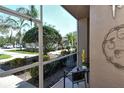 Relaxing screened lanai offering peaceful views of lush landscaping at 5250 Hyland Hills Ave # 1514, Sarasota, FL 34241