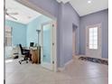 Hallway view leading to a home office with tile flooring and neutral paint at 5317 Coral Reef Way, Bradenton, FL 34211
