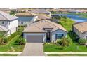 Charming single-story home featuring a well-manicured lawn and a gray brick driveway at 5317 Coral Reef Way, Bradenton, FL 34211