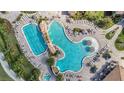 Overhead view of a resort-style pool with ample seating and tropical landscaping at 5517 Palmer Cir # 203, Bradenton, FL 34211