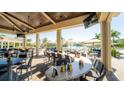 Outdoor dining area near pool offering a relaxing space to eat with a view of the pool and lush landscape at 5517 Palmer Cir # 203, Bradenton, FL 34211