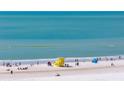 Beautiful gulf coast white sand beach on a sunny day with a lifeguard station at 5740 Midnight Pass Rd # 402, Sarasota, FL 34242