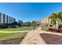 Beautifully landscaped grounds with walking path in a well-maintained condominium complex at 5740 Midnight Pass Rd # 402, Sarasota, FL 34242