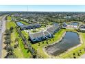 An aerial view of the townhome complex surrounded by ponds and lush landscaping at 5778 Windy Bay Ter, Nokomis, FL 34275