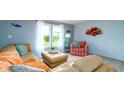 Bright living room with neutral walls, tile floors and comfortable, colorful furnishings at 5859 Lincoln Rd, Venice, FL 34293