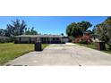 Well-kept single story home featuring a paved driveway and decorative brick columns at 605 15Th Avenue E Dr, Palmetto, FL 34221