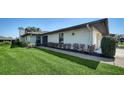 Home exterior with a well-manicured lawn, walkway and trimmed landscaping at 7347 Royal Birkdale Dr, Sarasota, FL 34238