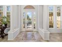 Elegant foyer with tile flooring, decorative columns, and a bright front door providing natural light at 8122 Spring Marsh Dr, University Park, FL 34201
