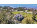 Expansive aerial shot showcases a stunning coastal home surrounded by lush tropical landscaping at 92 Tidy Island Blvd, Bradenton, FL 34210