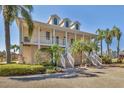 Elegant two-story home featuring a charming porch, well-manicured landscaping and welcoming curb appeal at 92 Tidy Island Blvd, Bradenton, FL 34210