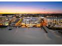 Stunning condo exterior with beach access and city views at dusk at 1035 Seaside Dr # 308, Sarasota, FL 34242