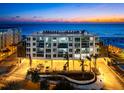 Beautiful condo exterior with beach access and city views at dusk at 1035 Seaside Dr # 308, Sarasota, FL 34242