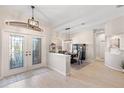 Welcoming foyer with tiled floors, decorative double doors, and an open view into the dining area at 12736 Penguin Dr, Bradenton, FL 34212