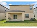 View of the covered patio overlooking the lawn in the backyard at 13414 Sunset Sapphire Ct, Parrish, FL 34219