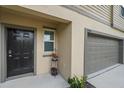 Close up of front door, address, and garage door on a two story home at 13414 Sunset Sapphire Ct, Parrish, FL 34219