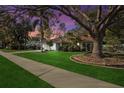 Beautiful home with a lovely lawn, complemented by a vibrant sunset sky at 1354 Lucaya Ave, Venice, FL 34285