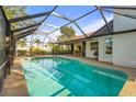 Screened-in pool area featuring clear blue water and a view of the backyard at 1354 Lucaya Ave, Venice, FL 34285
