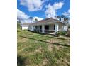 Expansive backyard featuring a covered patio, ideal for outdoor entertaining and relaxation at 1402 Jakway Rd, North Port, FL 34288