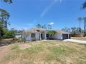Well-maintained single-story home with a two-car garage, lush landscaping, and a cozy front entrance at 1402 Jakway Rd, North Port, FL 34288