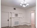 Elegant living room featuring a decorative fireplace, chandelier and beautiful natural lighting at 1404 W Granfield Ave, Plant City, FL 33563